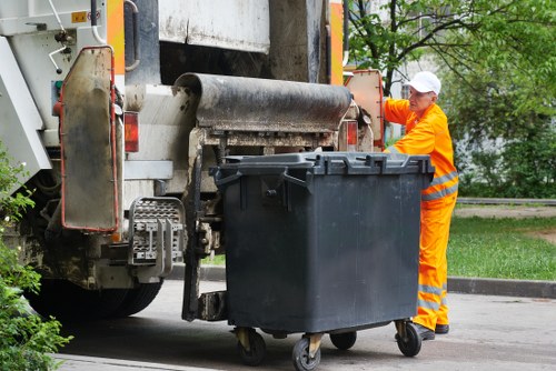 Workers using PPE while clearing garden debris