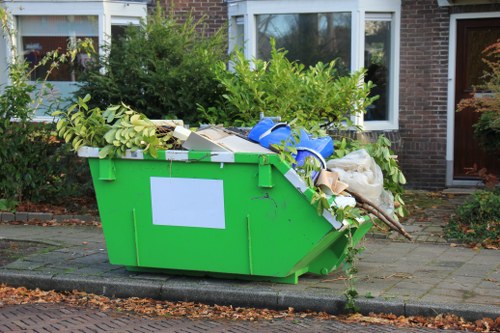 Workers loading garden waste into a van in Hoxton
